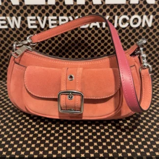 La cartera Ashton Mini Shoulder Bag de Coach es una pieza compacta, versátil y sofisticada, ideal para mujeres que buscan un bolso pequeño con estilo. Disponible en Trendstore Chile, este modelo en color rosado destaca por su tono suave y femenino. Confeccionada en gamuza con detalles en cuero liso, ofrece una textura elegante y un acabado refinado que eleva cualquier outfit. Su diseño minimalista y tamaño práctico la convierten en una opción perfecta para llevar lo esencial con estilo. Cuenta con cierre superior con cremallera que mantiene tus pertenencias seguras, además de un bolsillo exterior con broche que permite acceso rápido a objetos pequeños. Incluye asa corta desmontable para llevar al hombro y correa larga ajustable que permite usarla cruzada, adaptándose a diferentes estilos y ocasiones. Detalles del producto: Tipo: mini bolso / shoulder bag / crossbody mujer Material: gamuza y cuero liso Forro: tela Medidas: 19,7 cm (largo) x 8,9 cm (alto) x 5,7 cm (ancho) Asa corta desmontable: 21,6 cm Correa desmontable: 57,2 cm Cierre superior con cremallera Exterior: bolsillo con broche Color: rosado Código de producto: CDB12 En Trendstore Chile ofrecemos productos 100% originales, con compra segura y envíos a todo Chile.